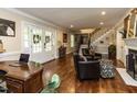 Spacious living room with hardwood floors, staircase, fireplace, and french doors at 107 Forest Rd, Oxford, NC 27565