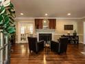 Inviting living room with hardwood floors, fireplace, and glass doors leading to another room at 107 Forest Rd, Oxford, NC 27565