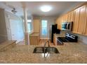 Open kitchen with granite countertops, stainless appliances and light wood cabinetry at 113 Conner Dr # 103, Chapel Hill, NC 27514