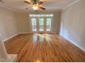 Bright living room with hardwood floors and access to outdoor balcony via glass doors at 113 Conner Dr # 103, Chapel Hill, NC 27514