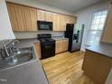 Modern kitchen with stainless steel sink, appliances and wood cabinets for ample storage with stylish countertops at 113 Conner Dv # 106, Chapel Hill, NC 27514
