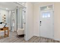 Inviting foyer with a white front door and sidelight, leading to a bright, airy living space at 137 Cultivator Ct, Angier, NC 27501