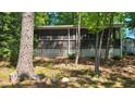 Quaint lake house with a screened porch offers a serene escape amidst nature at 1605 Sagamore Dr, Louisburg, NC 27549