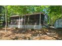 Charming lake house with a screened porch, providing a relaxing outdoor space at 1605 Sagamore Dr, Louisburg, NC 27549