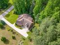 Overhead view of home and lush surroundings with a long driveway and mature trees at 1619 Carriage Dr, Franklinton, NC 27525