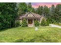 Charming home with a manicured lawn, lush landscaping, and stone accents at 1619 Carriage Dr, Franklinton, NC 27525