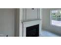 Close-up of a classic fireplace with a decorative white mantel at 183 Pecan Valley Way, Four Oaks, NC 27524
