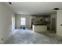 Open concept kitchen featuring white cabinets and a large island at 183 Pecan Valley Way, Four Oaks, NC 27524
