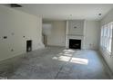 Spacious living room featuring a fireplace and large windows that let in natural light at 183 Pecan Valley Way, Four Oaks, NC 27524