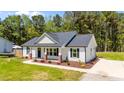 Well-maintained single-story home with manicured lawn, complementing its appealing facade at 1914 Jack Rd, Clayton, NC 27520