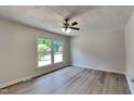 Bedroom featuring neutral paint, modern flooring, large window, and natural light at 202 November St, Garner, NC 27529