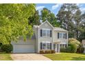 Traditional two-story home with black shutters and an attached garage at 203 Downing Bluff Dr, Morrisville, NC 27560