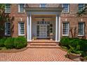 Elegant brick entrance with white columns, brick steps, and manicured landscaping at 205 Buncombe St, Raleigh, NC 27609