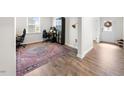 Inviting entryway featuring hardwood floors, a stylish rug, a functional office space, and natural light at 2415 Ivy Knoll Dr, Mebane, NC 27302
