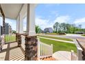 Inviting front porch view showcasing stone accents, white railings, and a glimpse of the neighborhood at 2415 Ivy Knoll Dr, Mebane, NC 27302