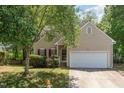 Charming two-story home featuring a well-maintained lawn, lush tree, and attached two-car garage at 2540 Beech Gap Ct, Raleigh, NC 27603