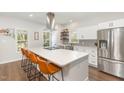 Bright kitchen with a large island, stainless steel appliances, white cabinetry, and modern fixtures at 2540 Beech Gap Ct, Raleigh, NC 27603