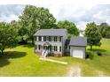 Traditional two-story home with gray siding, black shutters, and a large, grassy yard at 3004 Red Cir, Willow Springs, NC 27592