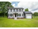 Charming two-story home with gray siding, black shutters, and a well-manicured lawn at 3004 Red Cir, Willow Springs, NC 27592