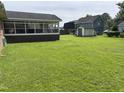 Spacious backyard showcasing a lush lawn and the exterior of the home at 405 Taylor Dr, Rocky Mount, NC 27803