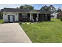 Charming brick and vinyl sided single story home with a well-manicured front yard and inviting entrance at 405 Taylor Dr, Rocky Mount, NC 27803