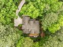 Overhead view of home surrounded by mature trees, with a deck visible in the backyard at 406 Bakewell Ct, Wake Forest, NC 27587