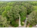 Aerial view of lush, green neighborhood with tree-lined streets and well-maintained homes at 406 Bakewell Ct, Wake Forest, NC 27587