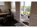 View from dining area to a screened porch with outdoor seating and neighborhood views at 428 Parlier Dr, Apex, NC 27523