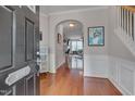 Bright foyer with hardwood floors, elegant wainscoting, and an arched entryway at 4306 Brynwood Ave, Durham, NC 27713