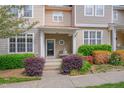 Inviting townhouse featuring lush landscaping and a charming covered entrance with seating at 4306 Brynwood Ave, Durham, NC 27713