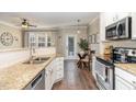 Bright kitchen boasts granite countertops, stainless appliances, and hardwood floors at 521 Village Loop Dr, Apex, NC 27502