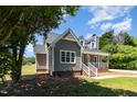 View of home's siding, covered porch, brick foundation, and windows showing an updated home at 5337 Nc Hwy 96, Selma, NC 27576