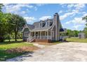 Well-maintained home with covered porch, brick foundation, and mature trees in a suburban setting at 5337 Nc Hwy 96, Selma, NC 27576