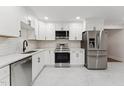 Newly renovated kitchen featuring modern stainless steel appliances, white cabinets, and marble countertops at 620 Wexford Dr, Raleigh, NC 27603