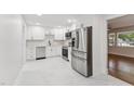 Modern, open kitchen featuring sleek stainless steel appliances and stylish white cabinets with plenty of counter space at 620 Wexford Dr, Raleigh, NC 27603
