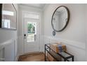 Bright entryway with modern wainscoting, wood-look floors, and a front door with glass inserts at 680 Beacon Hill Rd # 52, Lillington, NC 27546