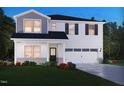 New two-story home showcasing white siding, a two-car garage, and professionally landscaped front yard at 737 Deschutes Dr, Garner, NC 27529