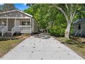 Long driveway leading to a gray house surrounded by lush greenery at 806 Martin Luther King Jr Dr, Smithfield, NC 27577