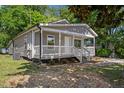 Quaint gray house with a welcoming front porch and manicured landscaping at 806 Martin Luther King Jr Dr, Smithfield, NC 27577