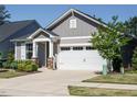 Attractive gray house with a white garage door and stone-accented entryway at 816 Still Willow Ln, Wendell, NC 27591