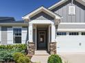 Charming front entrance with stone pillars, white trim, and a glass-paneled front door at 816 Still Willow Ln, Wendell, NC 27591