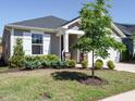 Well-maintained front yard with lush green grass, shrubbery, and a decorative tree at 816 Still Willow Ln, Wendell, NC 27591