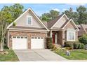 Charming single-story home featuring a two-car garage, brick facade, and inviting front garden at 913 S South Bend Dr, Durham, NC 27713