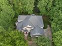 A bird's-eye view reveals a well-maintained home nestled among lush trees with ample privacy at 927 Jones Wynd, Wake Forest, NC 27587