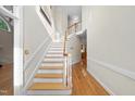 Bright foyer features hardwood floors and a staircase leading to the upper level at 927 Jones Wynd, Wake Forest, NC 27587