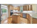 Well-equipped kitchen with wood cabinets, granite countertops, stainless steel appliances, and a center island at 927 Jones Wynd, Wake Forest, NC 27587