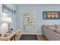 Light-filled foyer featuring laminate flooring, stylish console table and light blue walls at 102 Fairgrove Way Way, Cary, NC 27511