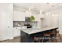 Modern kitchen with granite countertops, a large island, stainless steel appliances, and pendant lighting at 104 S Buggy Dr # 71P, Benson, NC 27504
