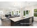 Open-concept kitchen and dining area featuring a large island and stainless steel appliances at 104 S Buggy Dr # 71P, Benson, NC 27504