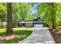 Charming home surrounded by mature trees and well-maintained landscaping at 106 Silverwood Ln, Cary, NC 27518